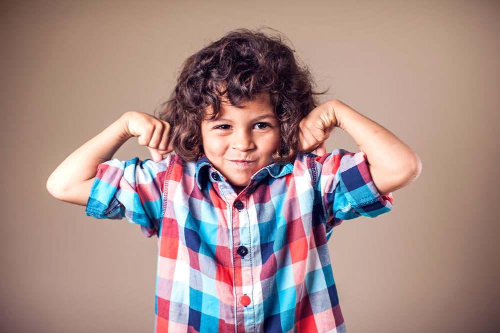 Photo of a boy flexing his muscles