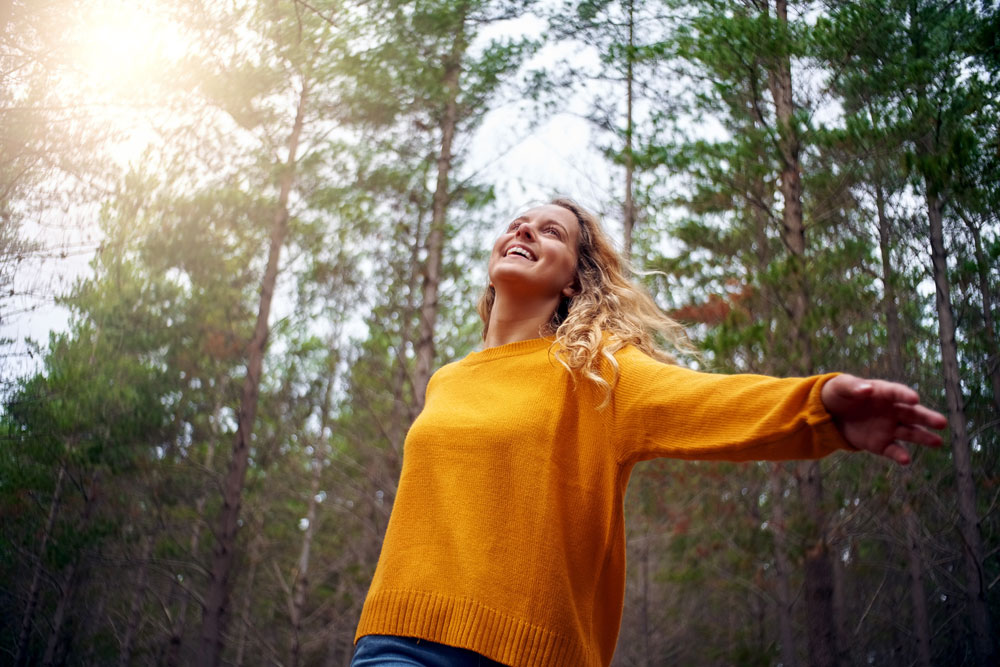 Woman standing in forest