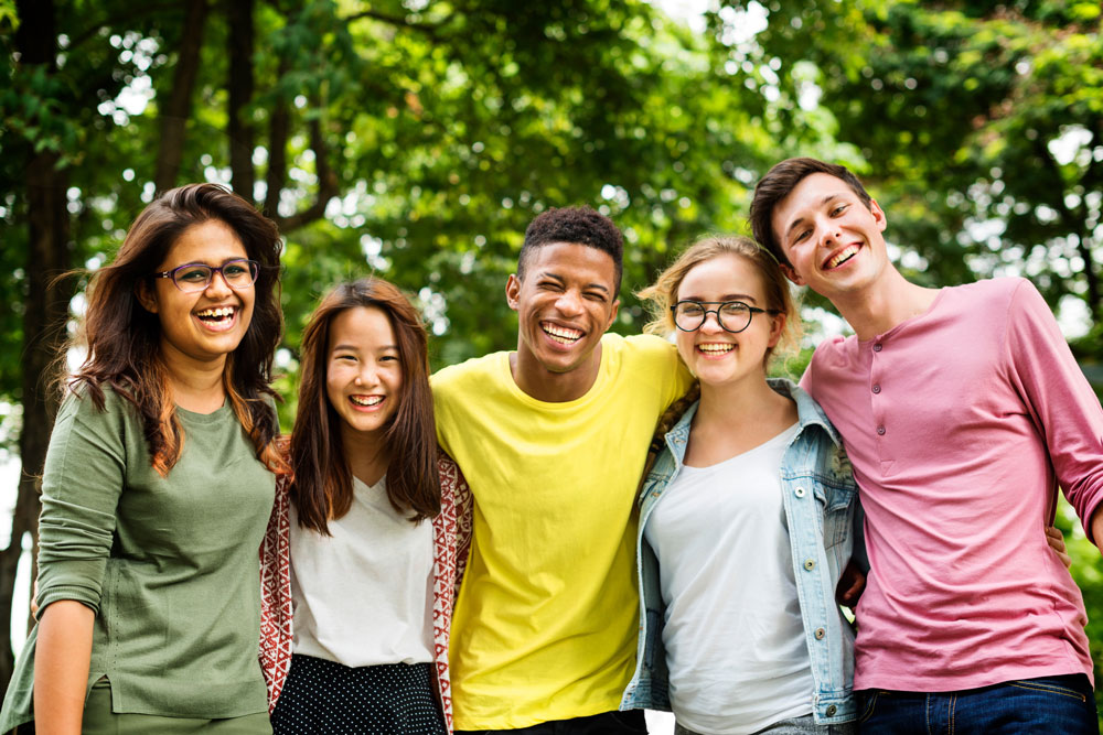 Teenagers in front of trees
