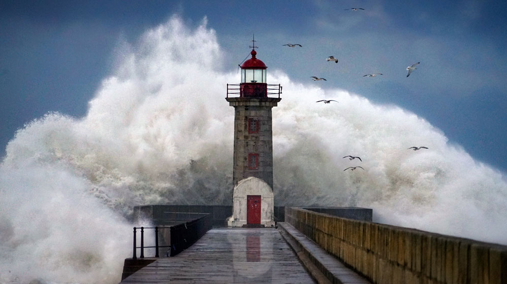 Lighthouse in front of crashing waves