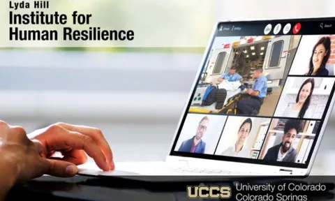Person looking at computer screen with other people in a training