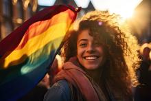 Woman standing in front of a pride flag